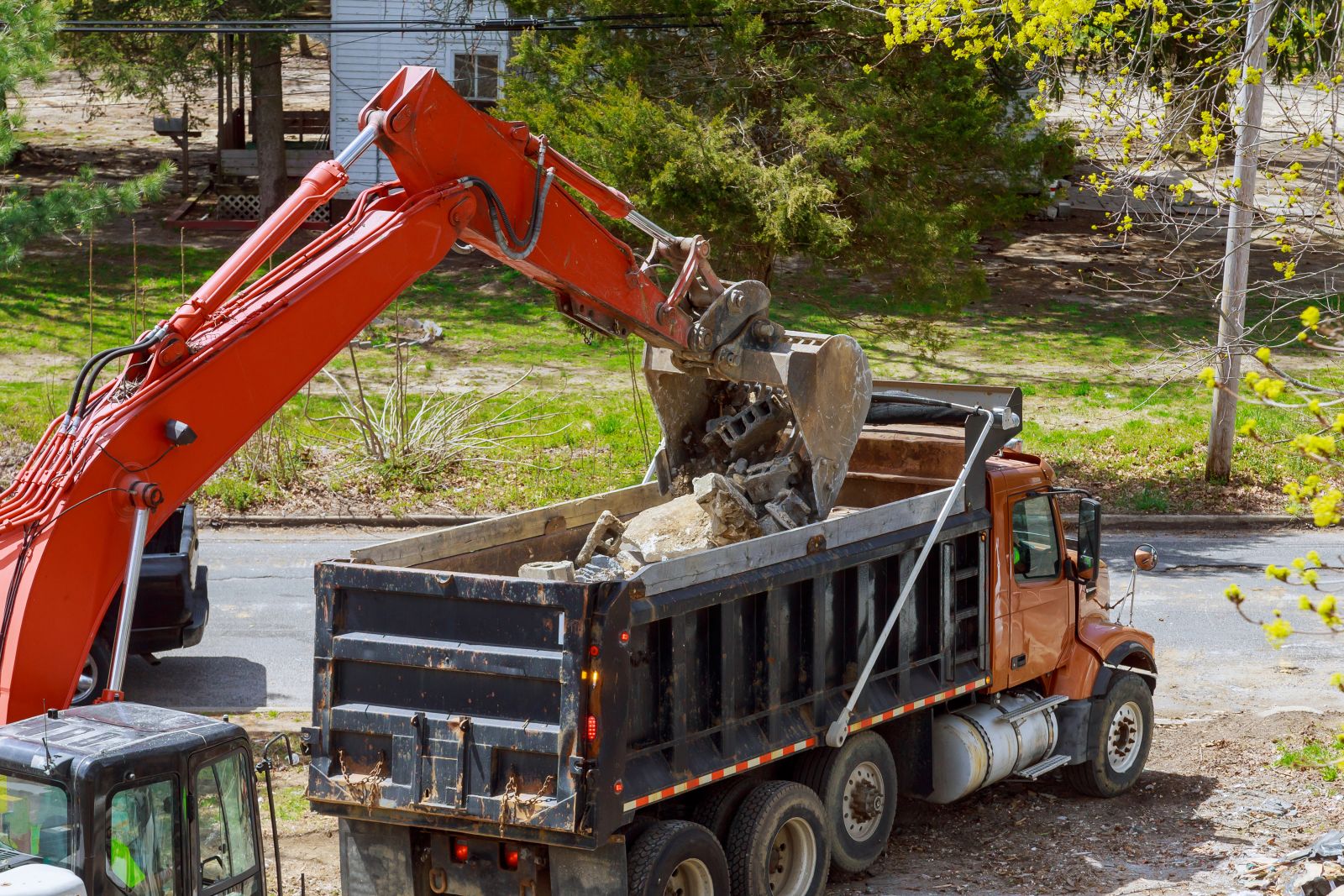 demolishing a building then hauling away the construction debris